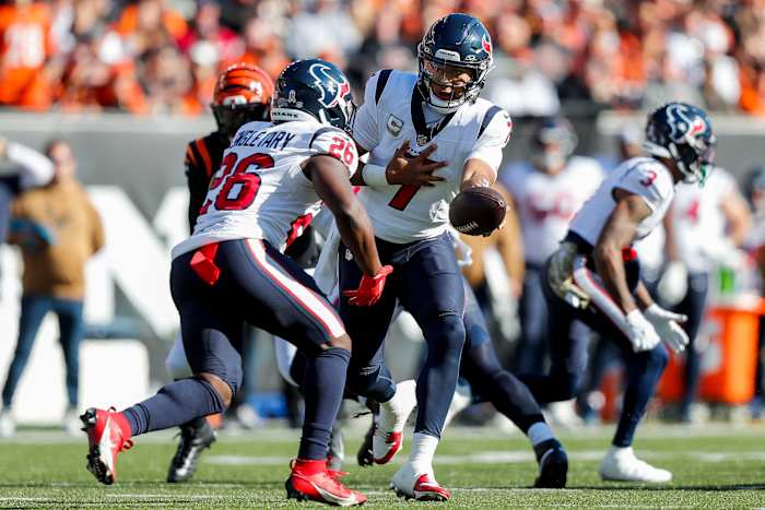 Houston Texans quarterback C.J. Stroud (7) hands the ball off to running back Devin Singletary (26) in the first half against the Cincinnati Bengals at Paycor Stadium.